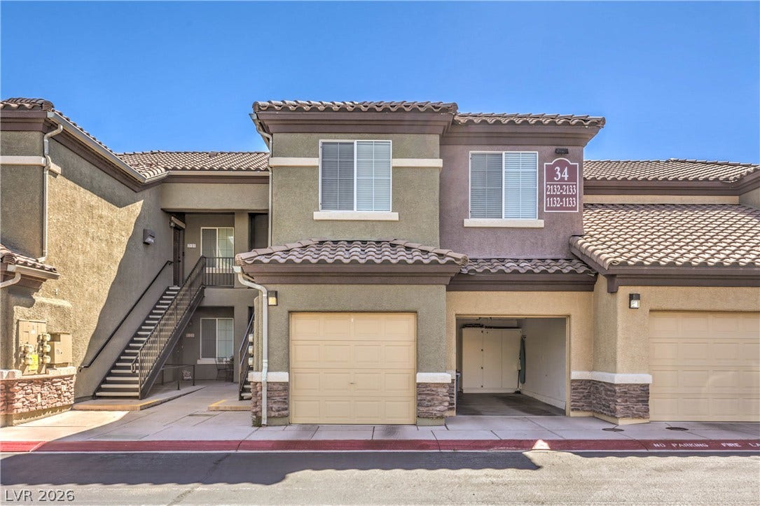 6868 Sky Pointe Drive, #1132, Las Vegas, NV 89131 Stucco exterior finishes and tiled roofing create a classic southwestern architectural style.
