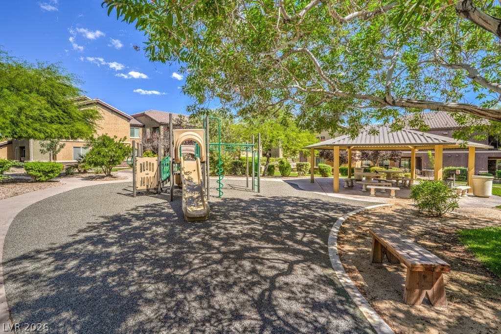 6868 Sky Pointe Drive, #1132, Las Vegas, NV 89131 Mature trees shade a communal recreation area featuring a playground structure and covered picnic pavilion.