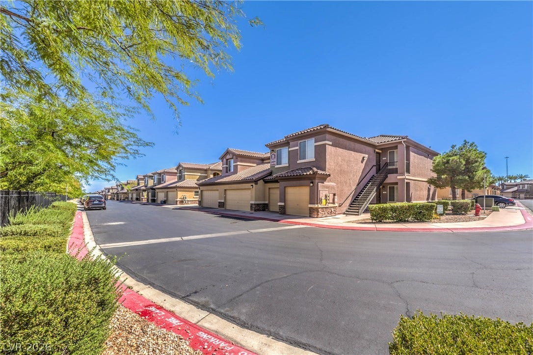 6868 Sky Pointe Drive, #1132, Las Vegas, NV 89131 Stucco exteriors and tiled roofs define these multi-level residences situated along a paved community drive.