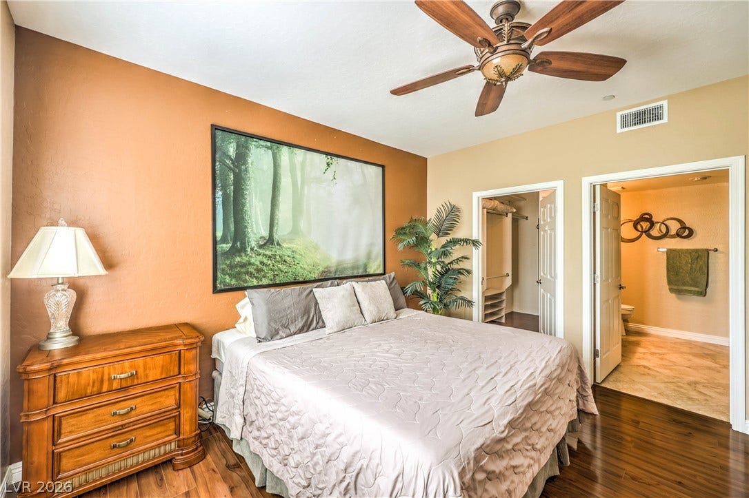 6868 Sky Pointe Drive, #1132, Las Vegas, NV 89131 Rich hardwood flooring pairs beautifully with smooth plastered walls in this primary suite.