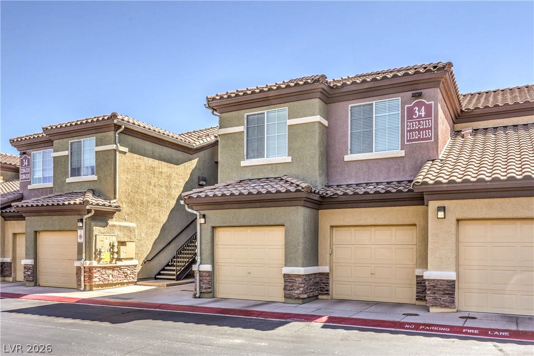 6868 Sky Pointe Drive, #1132, Las Vegas, NV 89131 Mediterranean style architecture shines with classic tiled roofing and private garage entries.