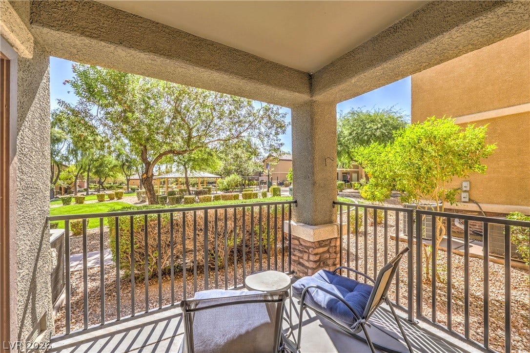 6868 Sky Pointe Drive, #1132, Las Vegas, NV 89131 An inviting covered balcony overlooks the professionally landscaped common areas and mature trees.