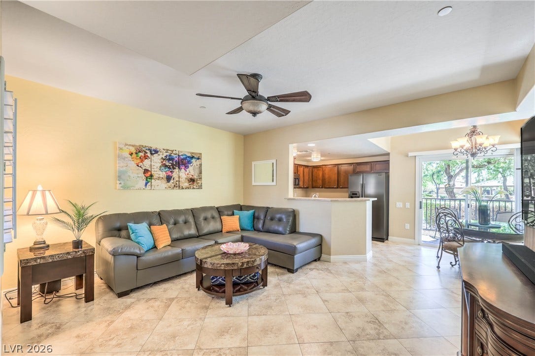 6868 Sky Pointe Drive, #1132, Las Vegas, NV 89131 An open-concept living area flows into the kitchen under high ceilings with tile flooring.