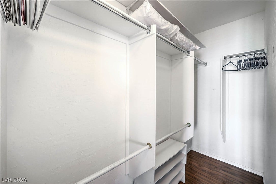 6868 Sky Pointe Drive, #1132, Las Vegas, NV 89131 Organized built-in shelving and hanging rods maximize storage space above rich hardwood flooring.