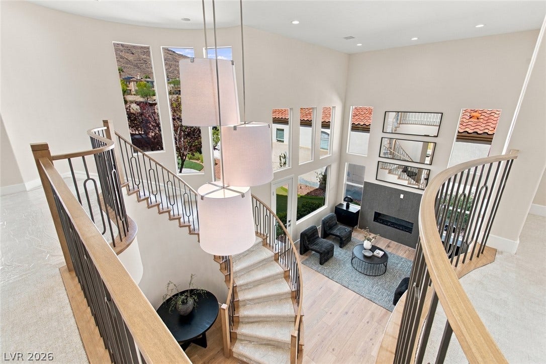 2837 Turtle Head Peak Drive, Las Vegas, NV 89135 Dramatic windows and a modern fireplace elevate this impressive double-height living room.