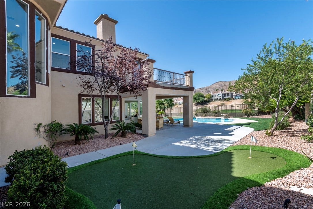 2837 Turtle Head Peak Drive, Las Vegas, NV 89135 An inviting backyard oasis features a custom putting green, concrete patio, and sparkling pool.