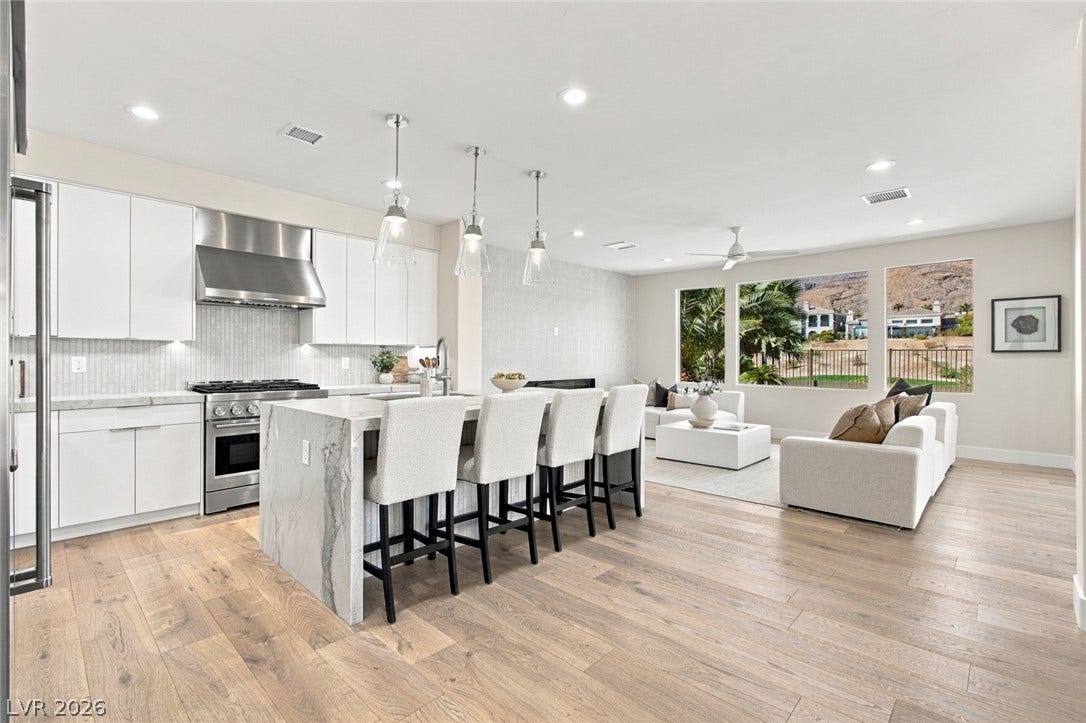 2837 Turtle Head Peak Drive, Las Vegas, NV 89135 Warm hardwood floors anchor this open-concept layout connecting the kitchen to the bright living area.