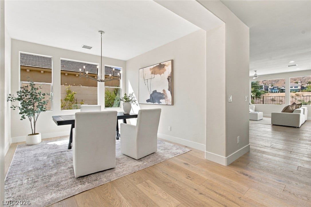 2837 Turtle Head Peak Drive, Las Vegas, NV 89135 Hardwood floors and natural light from large windows define this elegant dining area.