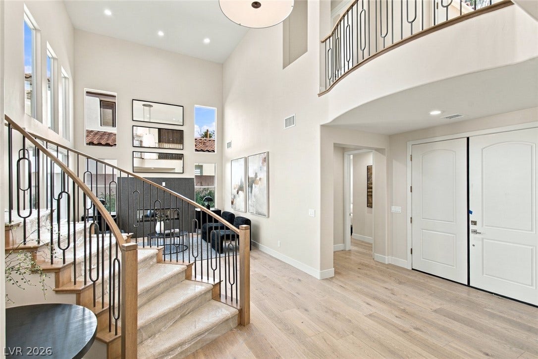 2837 Turtle Head Peak Drive, Las Vegas, NV 89135 Soaring ceilings and light hardwood floors create a grand first impression in this entryway.