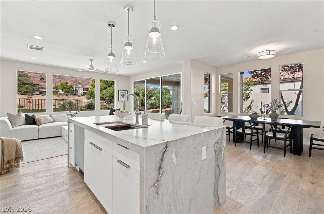 2837 Turtle Head Peak Drive, Las Vegas, NV 89135 Generous windows frame scenic desert vistas in this open-concept layout with light wood flooring.