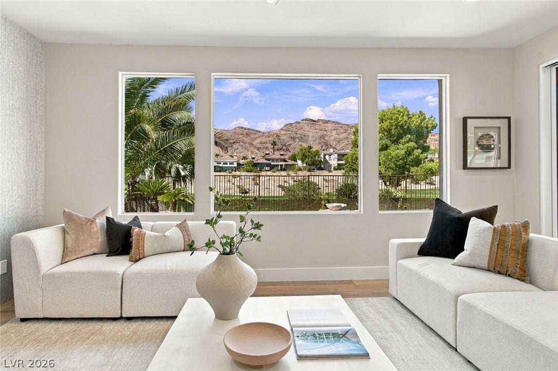 2837 Turtle Head Peak Drive, Las Vegas, NV 89135 Large picture windows frame spectacular mountain views from this light-filled living space.