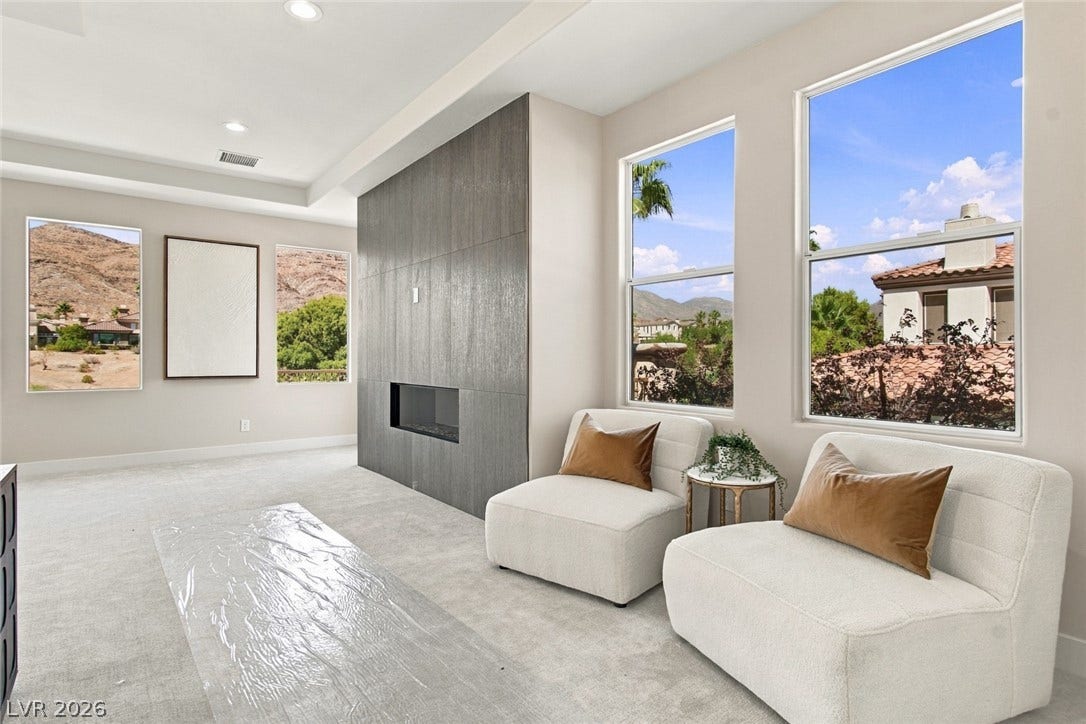 2837 Turtle Head Peak Drive, Las Vegas, NV 89135 Large windows frame picturesque desert and mountain vistas in this modern living space.