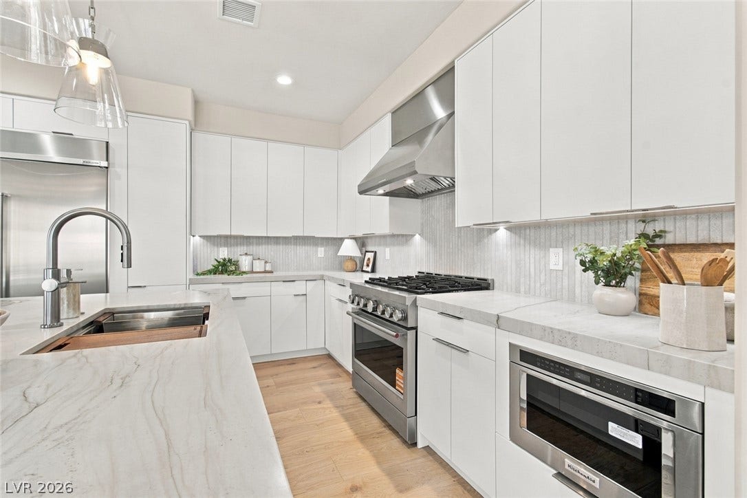 2837 Turtle Head Peak Drive, Las Vegas, NV 89135 Gleaming stone countertops and sleek modern cabinetry anchor this beautifully appointed kitchen workspace.