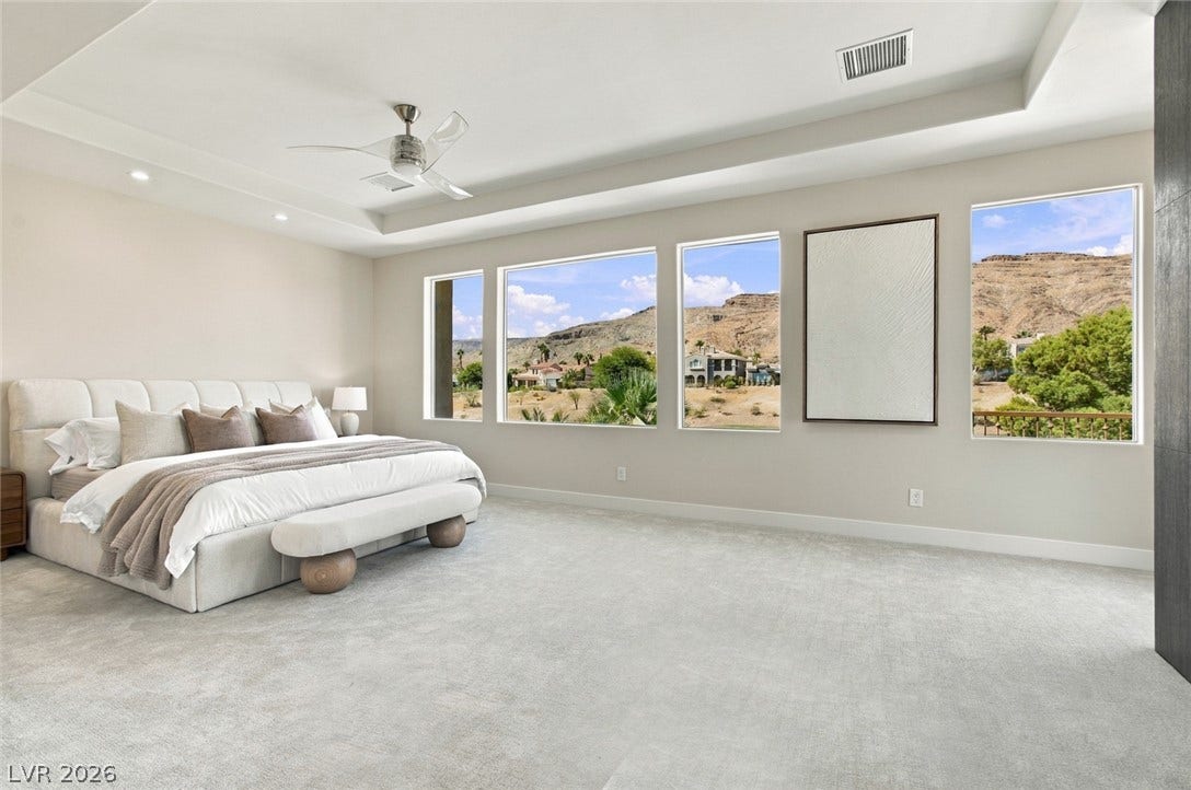 2837 Turtle Head Peak Drive, Las Vegas, NV 89135 Generous windows frame desert mountain views from this light-filled main bedroom.