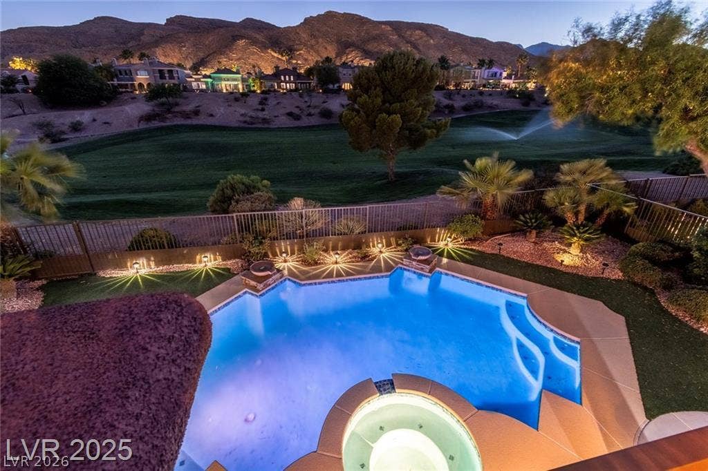2837 Turtle Head Peak Drive, Las Vegas, NV 89135 An inviting backyard pool overlooks a lush golf course with dramatic mountain views.