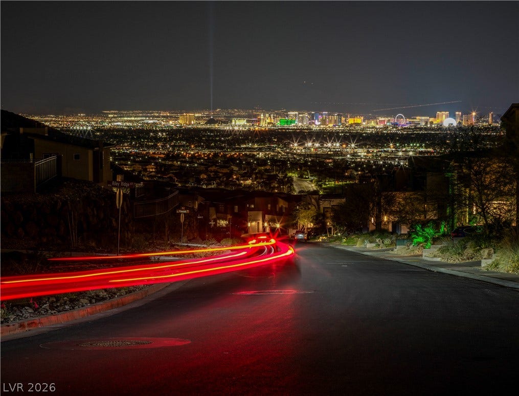 270 Shaded Canyon Drive, Henderson, NV 89012 Glimmering city skyline lights sparkle against the dark night sky from an elevated vantage point.