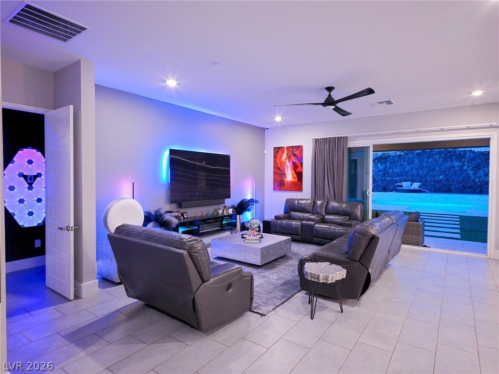 270 Shaded Canyon Drive, Henderson, NV 89012 An open living room transitions seamlessly to the outdoor pool deck through sliding glass doors.