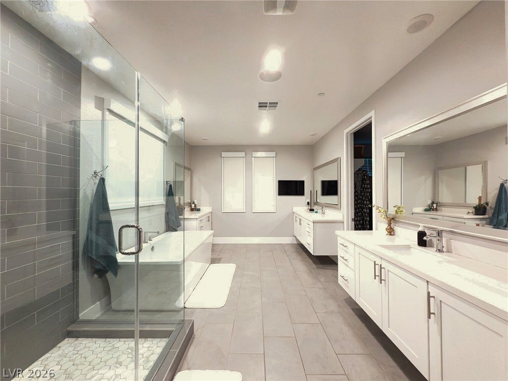 270 Shaded Canyon Drive, Henderson, NV 89012 Double vanities, a glass-enclosed shower, and a soaking tub define this modern space.