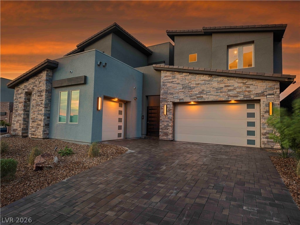 270 Shaded Canyon Drive, Henderson, NV 89012 Striking contemporary architecture pairs textured stone accents with a spacious paved driveway.