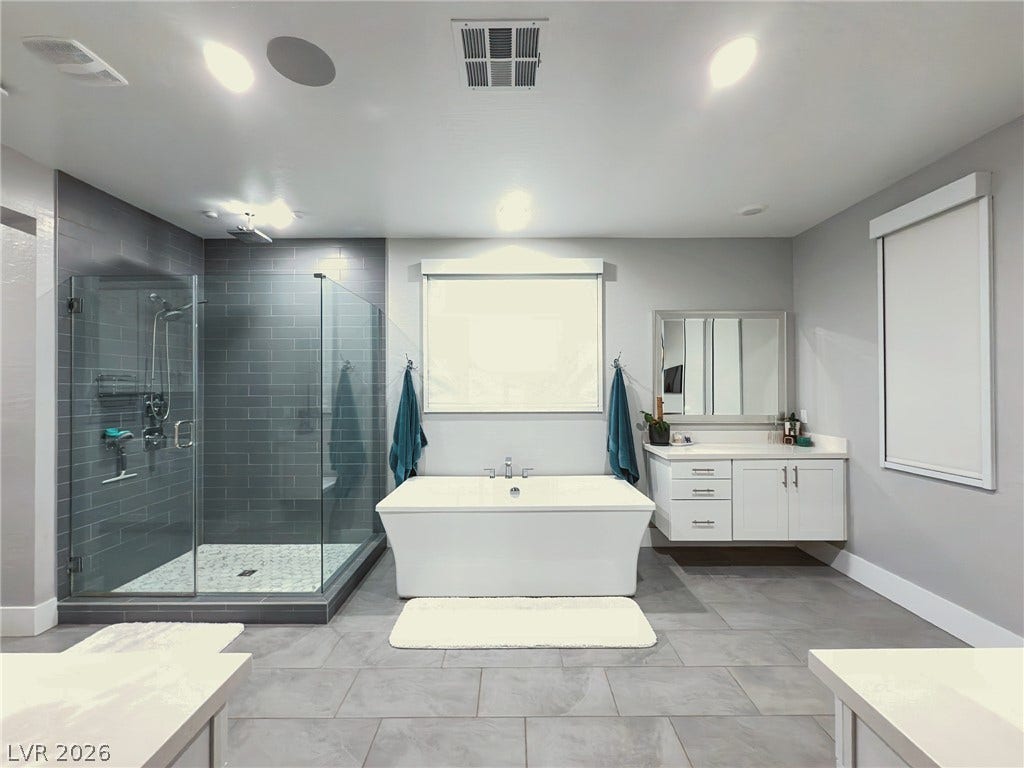 270 Shaded Canyon Drive, Henderson, NV 89012 A spacious layout showcases a freestanding soaking tub alongside a glass-enclosed walk-in shower.