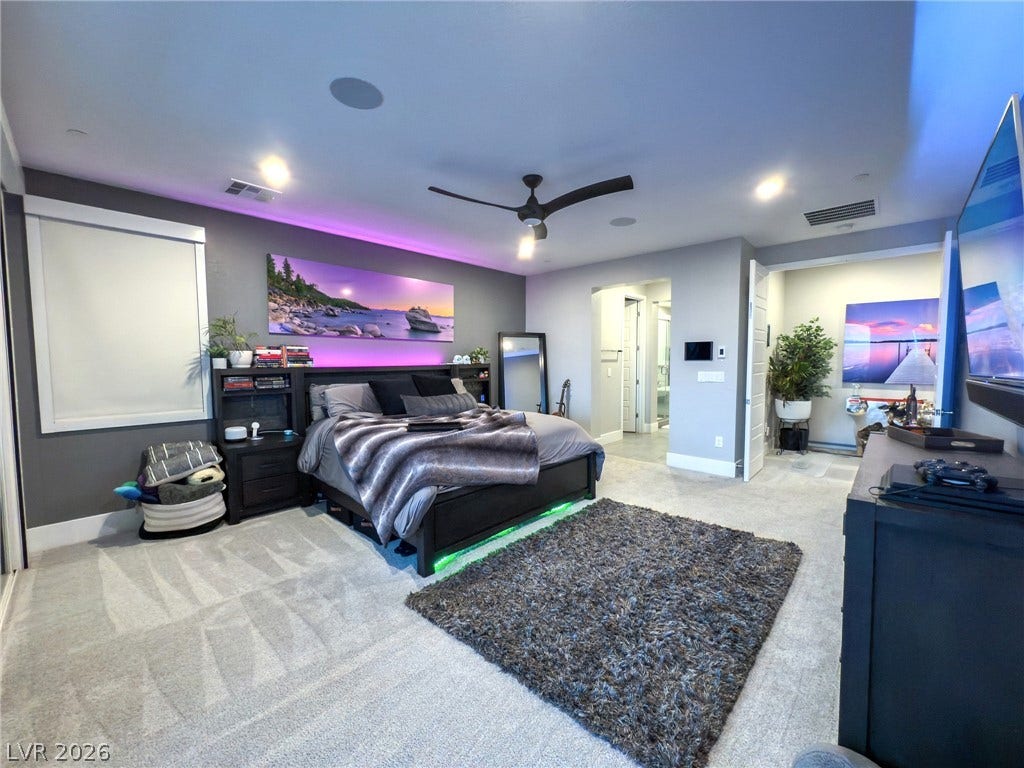 270 Shaded Canyon Drive, Henderson, NV 89012 A spacious bedroom features neutral plush carpeting, recessed lighting, and a modern open doorway.
