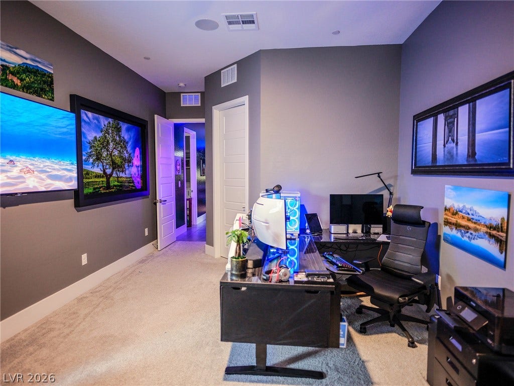 270 Shaded Canyon Drive, Henderson, NV 89012 A spacious home workspace features smooth drywall finishes and comfortable wall-to-wall carpeting.