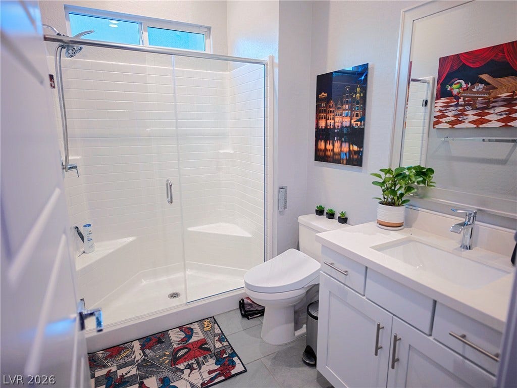 270 Shaded Canyon Drive, Henderson, NV 89012 Clean lines and a spacious glass-enclosed shower define this modern bathroom space.