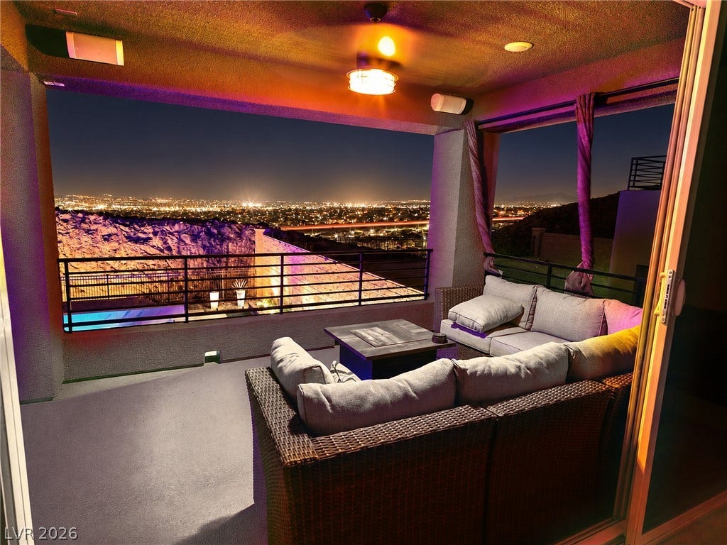 270 Shaded Canyon Drive, Henderson, NV 89012 A covered concrete terrace looks out over sparkling city lights and mountain views.