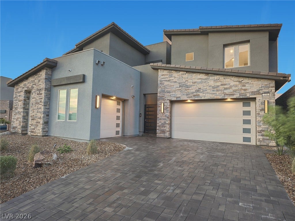 270 Shaded Canyon Drive, Henderson, NV 89012 A spacious paver driveway leads to this contemporary stone and stucco facade with split garage bays.