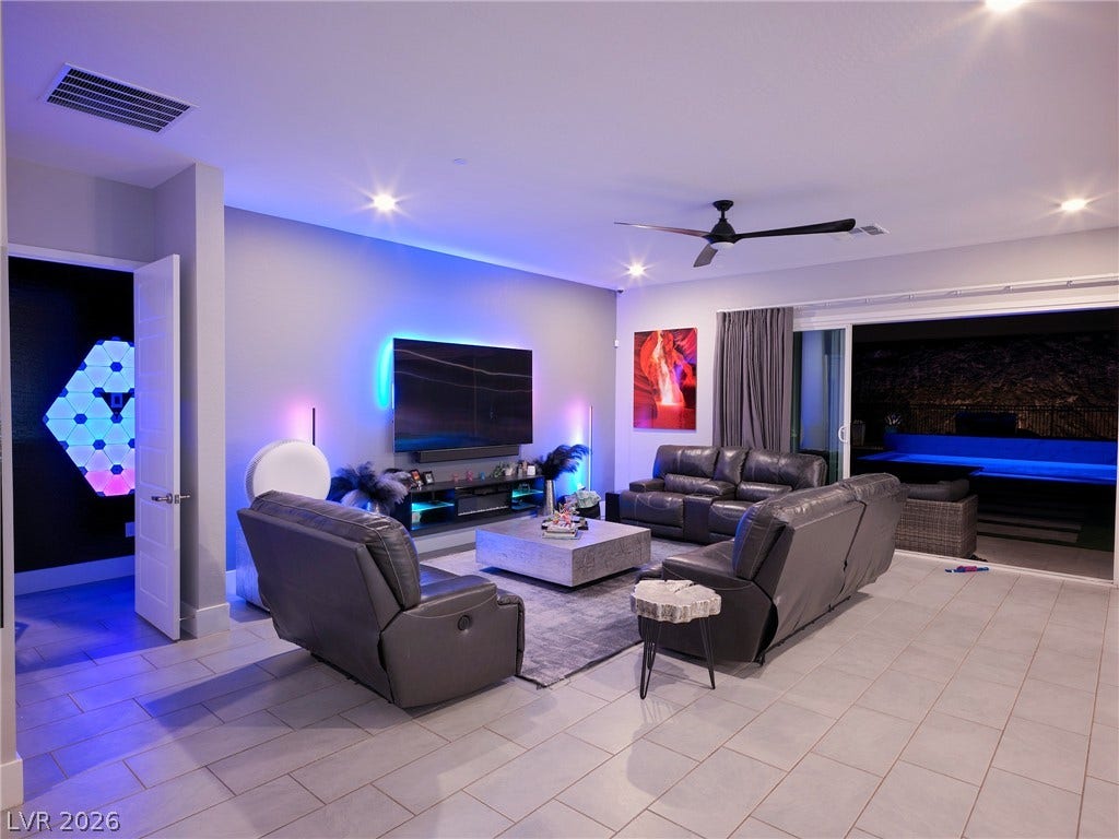 270 Shaded Canyon Drive, Henderson, NV 89012 Tiled flooring and broad sliding doors integrate this interior space with the pool area.