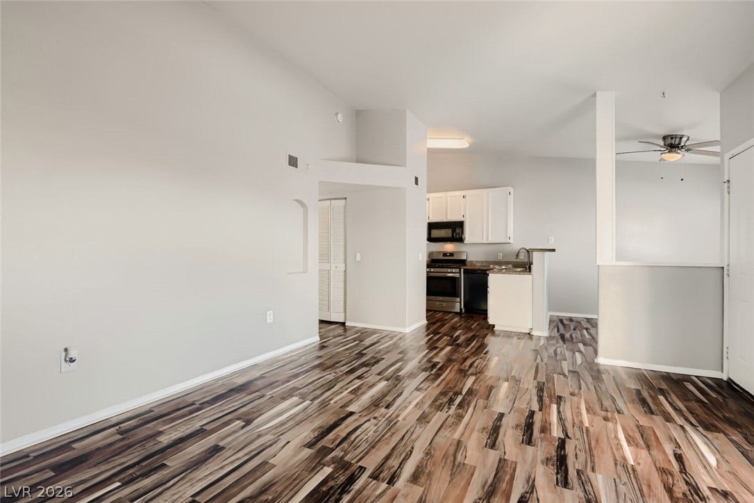 Richly grained wood flooring flows seamlessly through this open-concept layout.