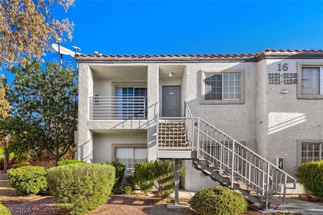 Stucco exterior walls and spanish tile roofing define this multi-level residential building.
