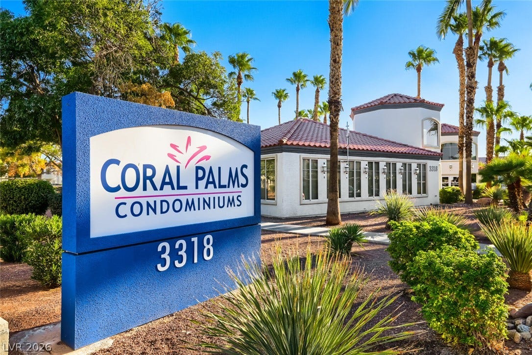Mediterranean architectural details and mature desert landscaping define this well-maintained community entrance.