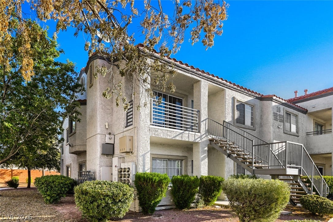 Classic stucco architecture showcases private balconies and integrated outdoor stairways.
