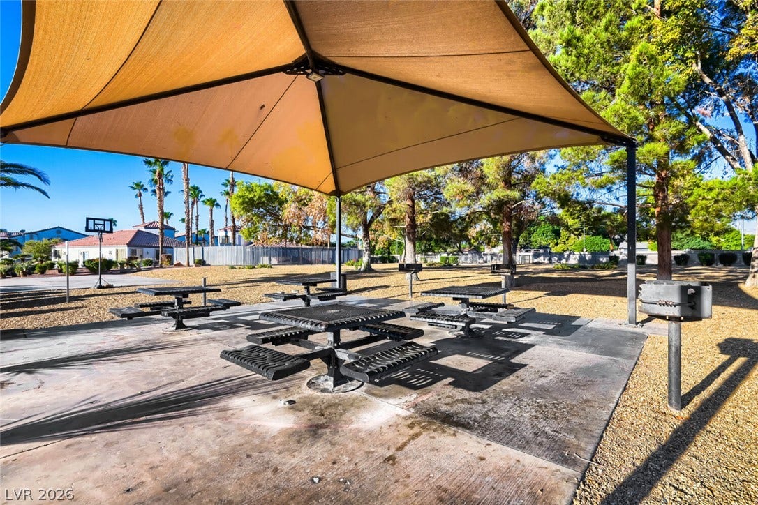 Shaded picnic tables and outdoor grills offer a park-like setting under mature trees.