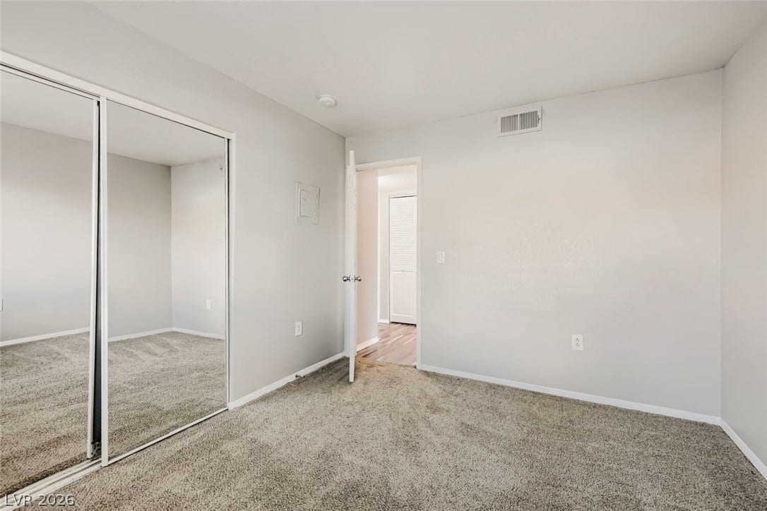 Plush carpeting and mirrored sliding closet doors complete this comfortable bedroom space.