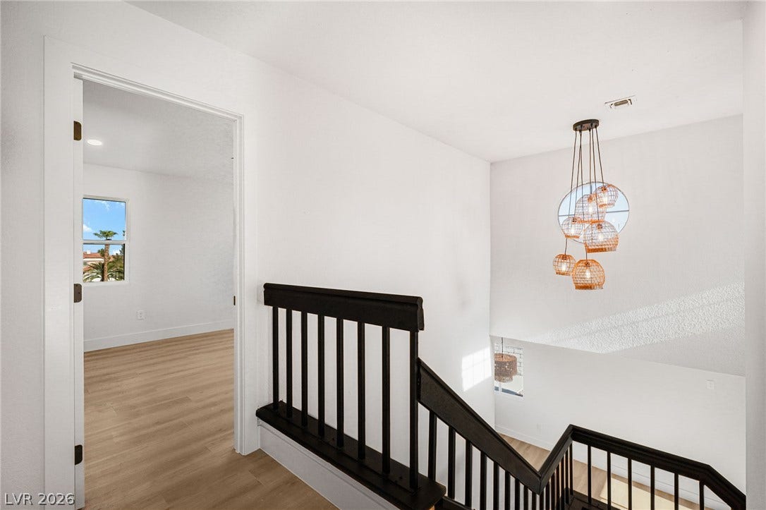 Clean lines and a stylish staircase landing connect the upper-level living areas.