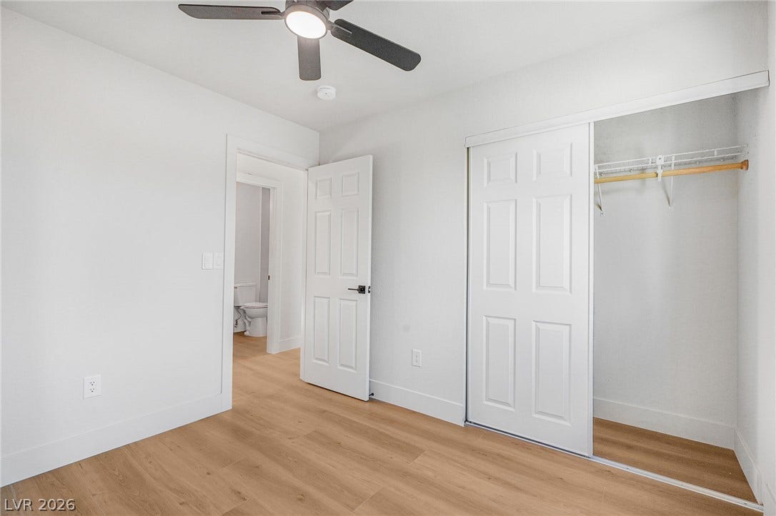 Smooth wood-style flooring and a built-in closet define this versatile room.