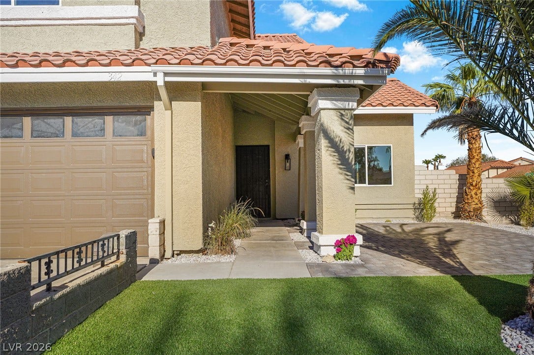 Clay tile roofing and stucco exterior walls create classic southwestern curb appeal.