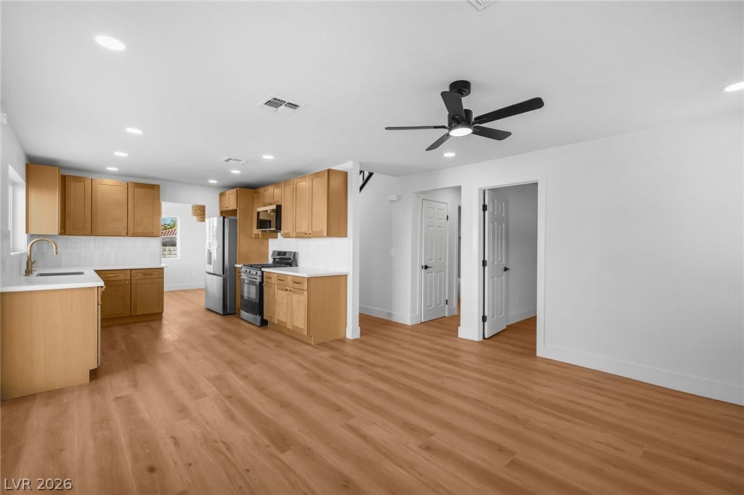 An open layout seamlessly connects the kitchen to the versatile living spaces.