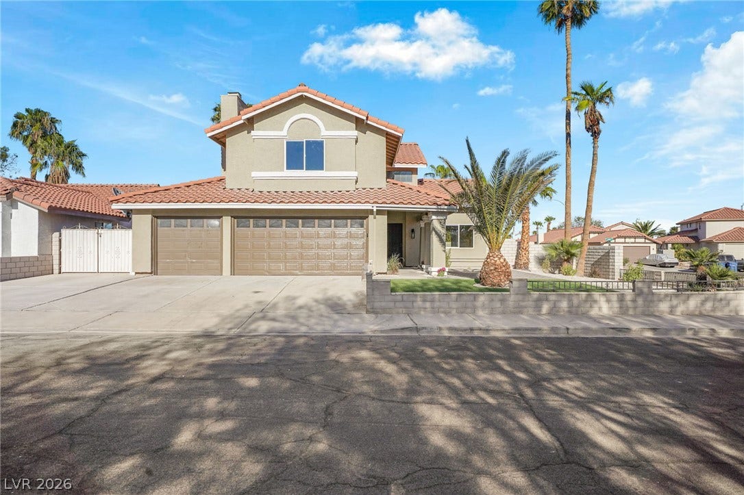 A classic Spanish tile roof accents this multi-level home with a spacious attached garage.