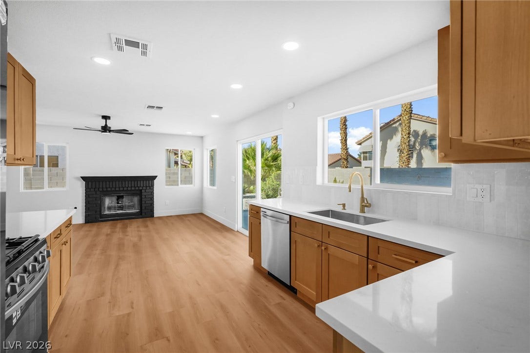 An open floorplan seamlessly connects the updated kitchen to the adjacent living area.