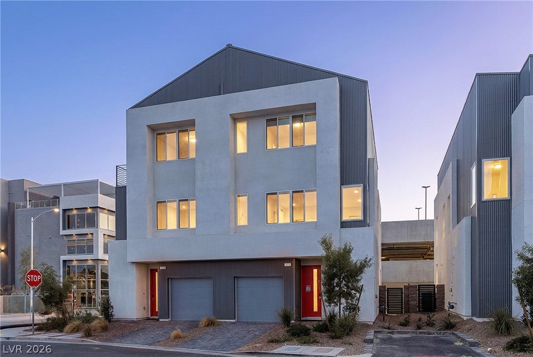 8629 Ensworth Street, #102, Las Vegas, NV 89123 Modern townhome facade showcases clean lines, vibrant red entry doors, and attached garages.