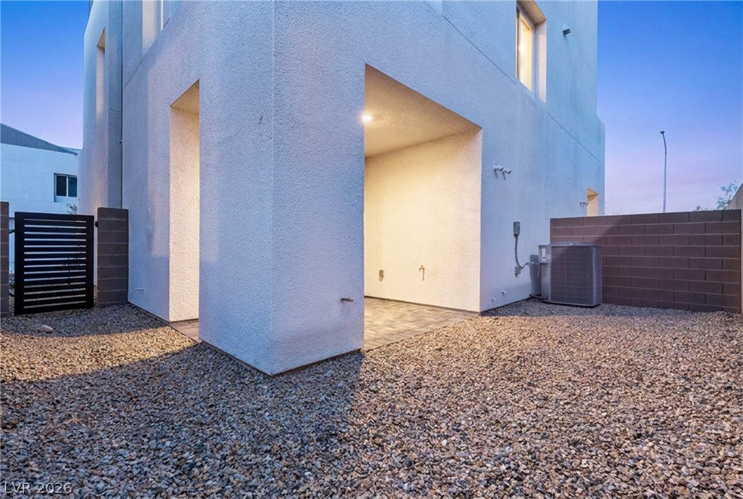 8629 Ensworth Street, #102, Las Vegas, NV 89123 A modern building facade boasts a covered patio area and a low-maintenance gravel yard.