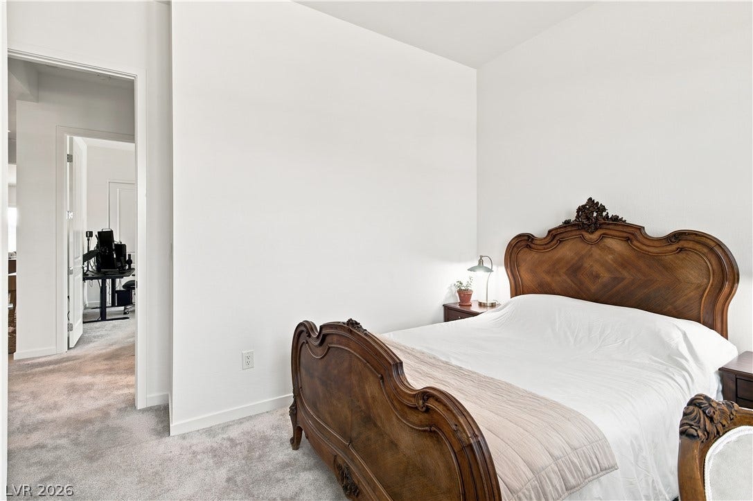 5745 N Golden Chase Court, Las Vegas, NV 89131 A restful bedroom showcases high ceilings, plush carpeting, and neutral walls.