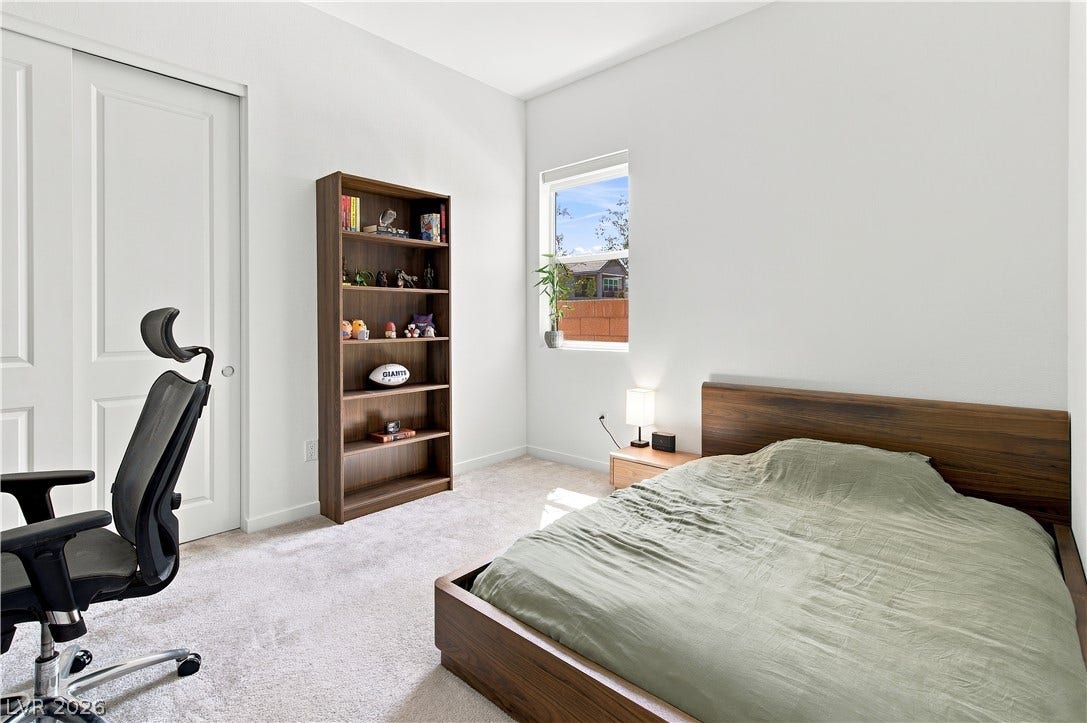 5745 N Golden Chase Court, Las Vegas, NV 89131 High ceilings and soft carpet floor define this comfortable secondary bedroom.