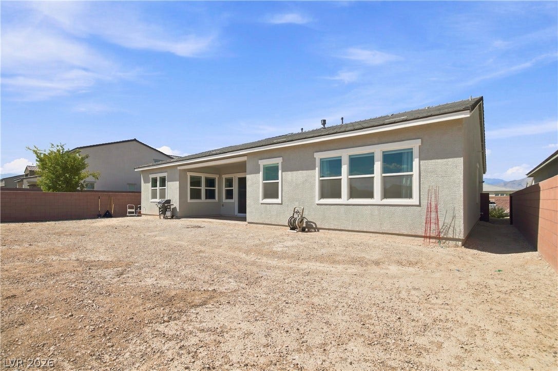 5745 N Golden Chase Court, Las Vegas, NV 89131 A spacious backyard area is ready for custom landscaping behind this modern stucco home.