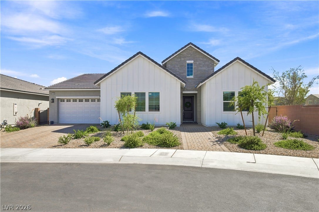 5745 N Golden Chase Court, Las Vegas, NV 89131 Gable rooflines and board-and-batten siding define this modern elevation with integrated stone accents.