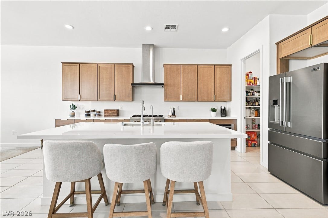 5745 N Golden Chase Court, Las Vegas, NV 89131 A spacious kitchen features a large central island, recessed lighting, and a walk-in pantry.