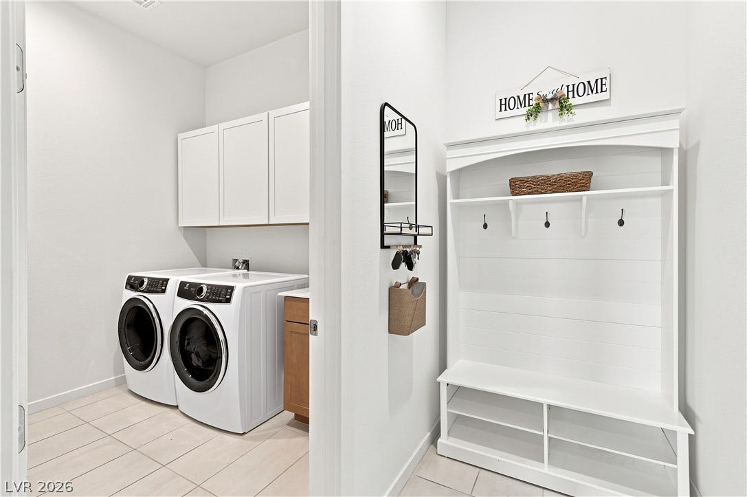 5745 N Golden Chase Court, Las Vegas, NV 89131 An organized mudroom area transitions seamlessly into a clean laundry space with tiled flooring.